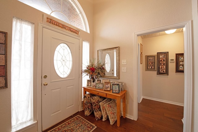 entryway with dark hardwood / wood-style flooring