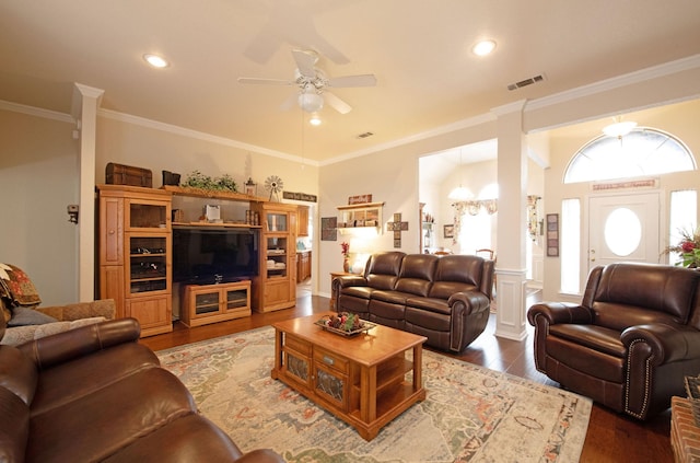 living room with crown molding, hardwood / wood-style flooring, and ceiling fan with notable chandelier