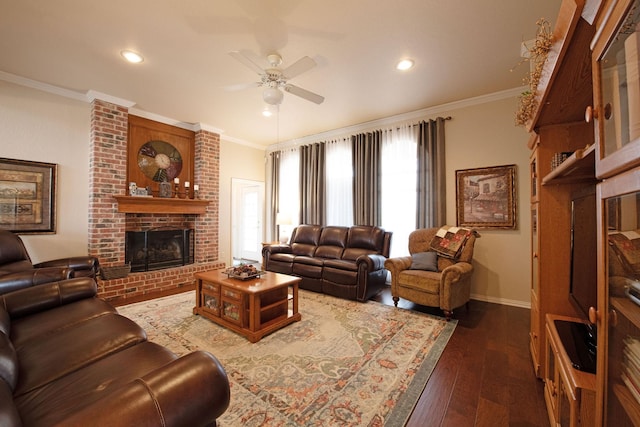 living room featuring ornamental molding, dark hardwood / wood-style flooring, ceiling fan, and a fireplace