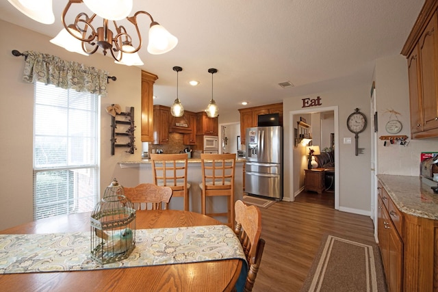 dining room featuring dark hardwood / wood-style flooring and a notable chandelier