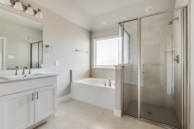 bathroom featuring independent shower and bath, vanity, and tile patterned flooring