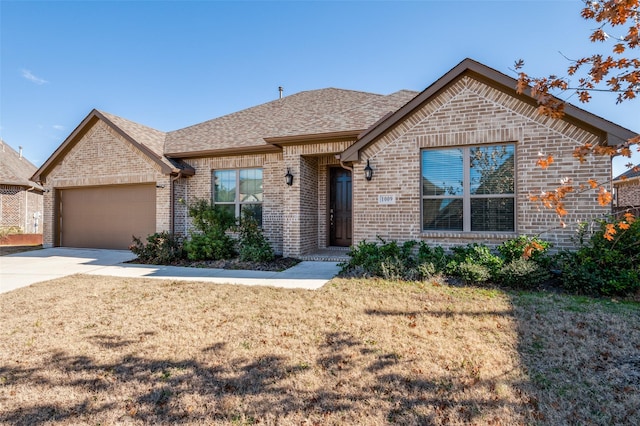 view of front of property with a garage and a front lawn