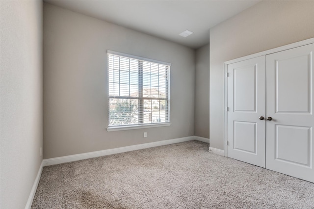 unfurnished bedroom with a closet and carpet flooring