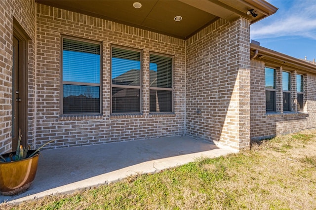 view of exterior entry featuring a patio