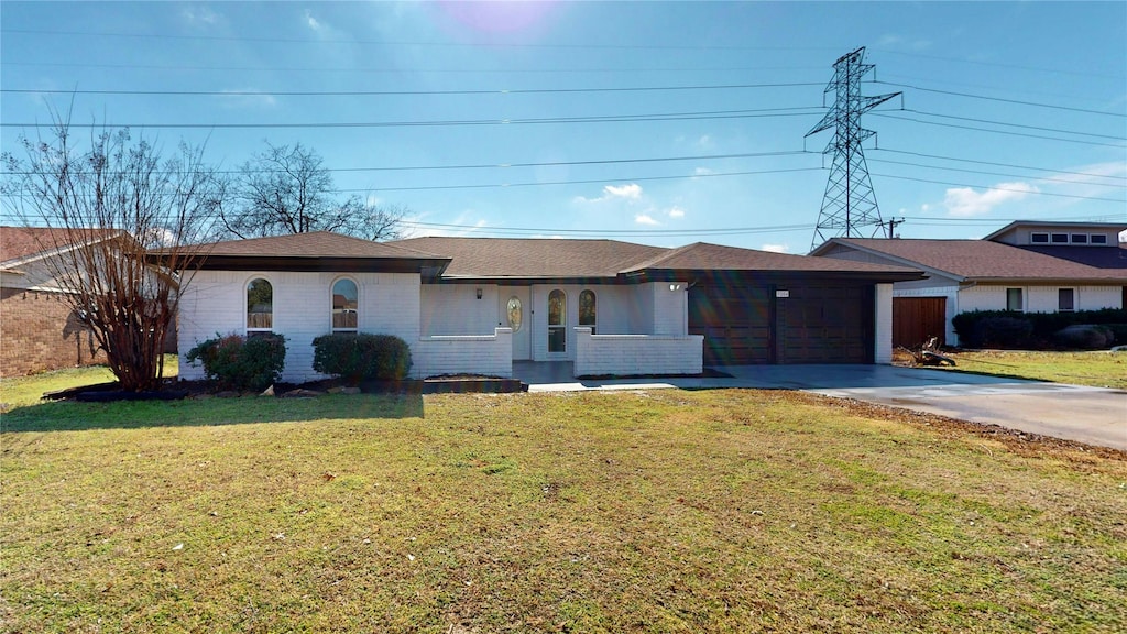 ranch-style home with a garage and a front yard