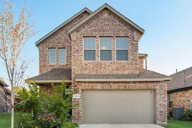 front of property featuring a garage and cooling unit