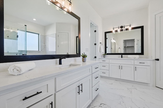 bathroom with vanity and a shower with door