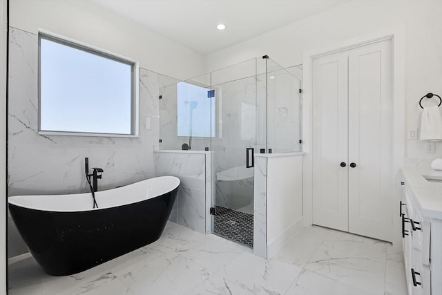 bathroom featuring independent shower and bath and vanity