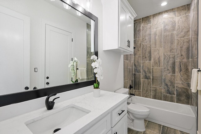 full bathroom featuring vanity, toilet, and tiled shower / bath