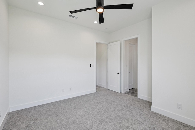 unfurnished bedroom with light colored carpet and ceiling fan