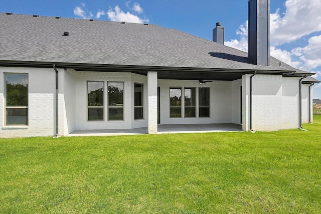 rear view of house with a lawn, ceiling fan, and a patio area