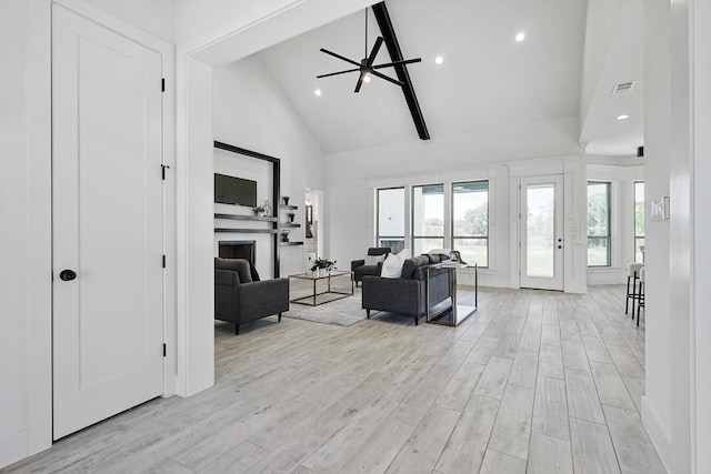 living room featuring beam ceiling, high vaulted ceiling, and light hardwood / wood-style flooring