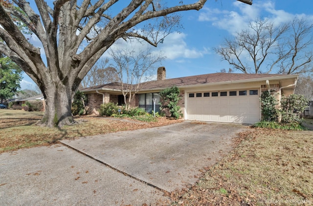 ranch-style home with a garage and a front lawn