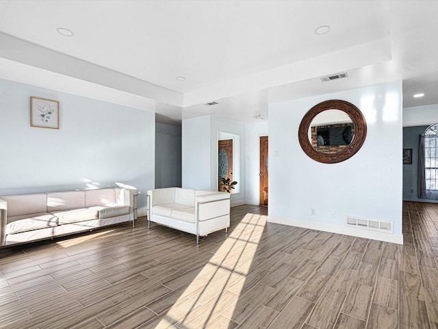 unfurnished living room featuring a raised ceiling