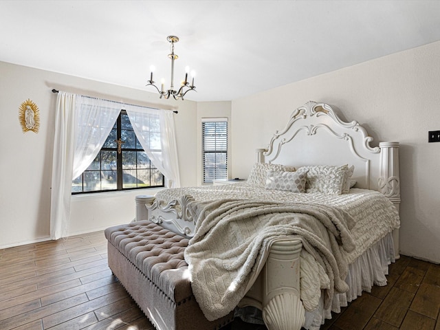 bedroom featuring multiple windows, an inviting chandelier, and dark hardwood / wood-style flooring