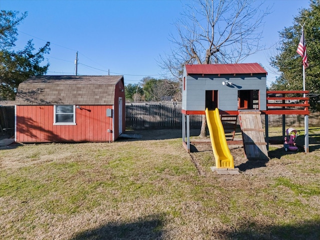 view of jungle gym with a yard and a storage unit