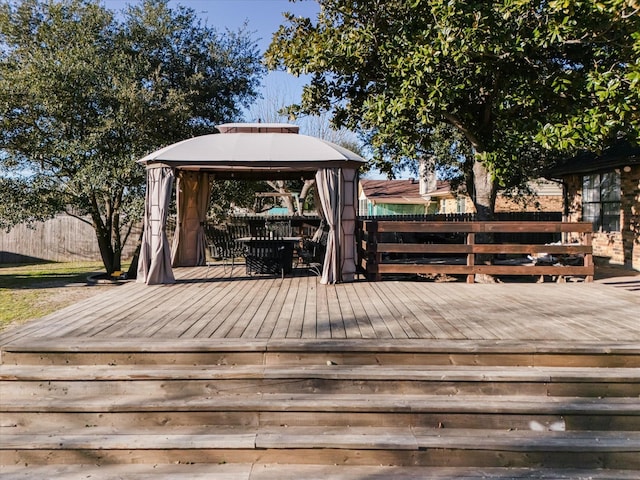 wooden terrace featuring a gazebo