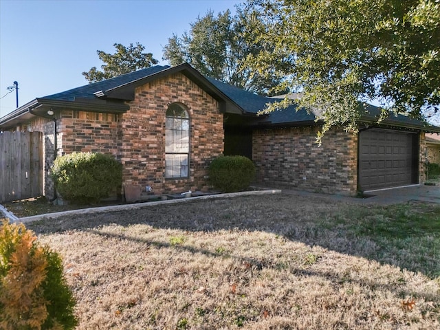 view of front of house with a garage and a front yard