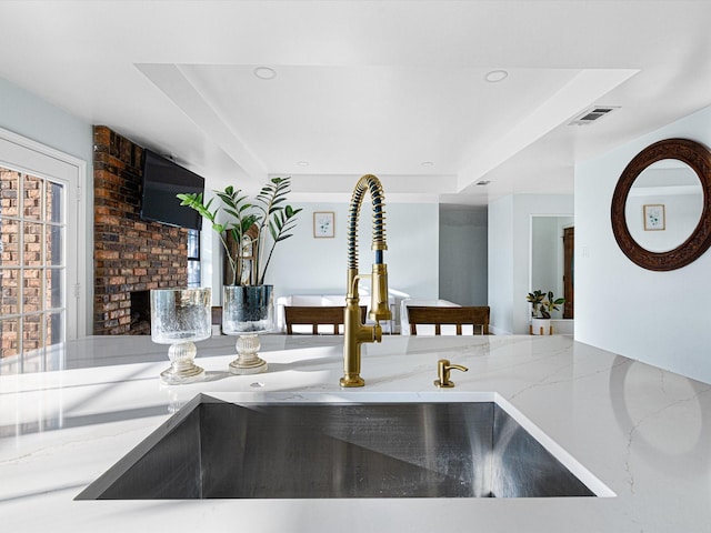 room details featuring sink and a tray ceiling