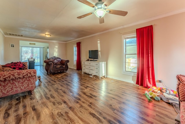 living room featuring hardwood / wood-style flooring, ceiling fan, and crown molding