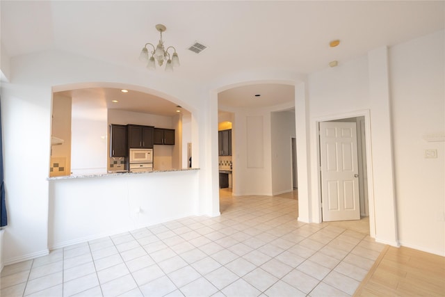 interior space featuring light tile patterned floors and a chandelier