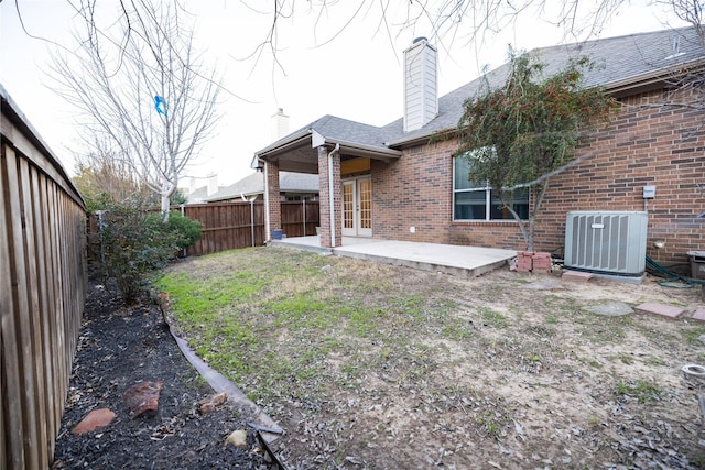 rear view of house with cooling unit and a patio