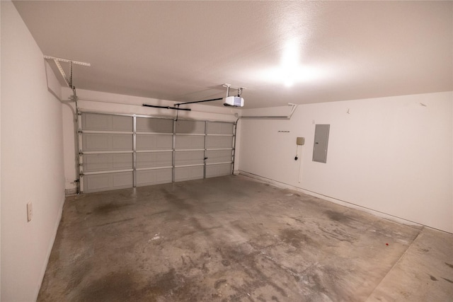 garage with a garage door opener and electric panel