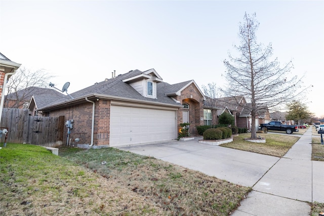 view of front of house featuring a garage and a front lawn