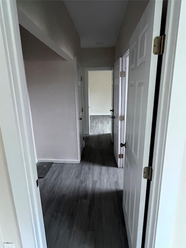 corridor featuring dark hardwood / wood-style flooring