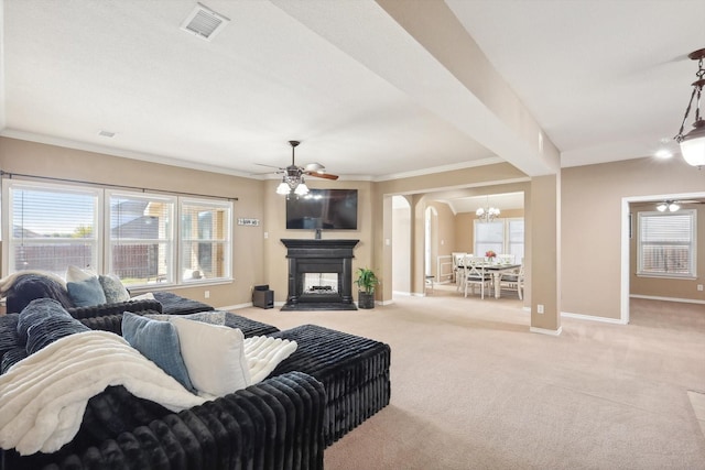 living room with light carpet, a fireplace with raised hearth, and baseboards