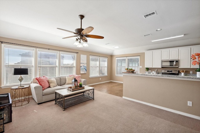 living area with visible vents, a ceiling fan, recessed lighting, baseboards, and light colored carpet