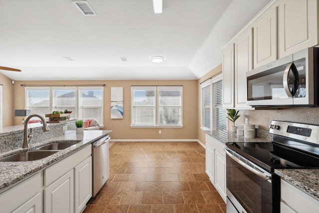 kitchen with a sink, visible vents, appliances with stainless steel finishes, and a healthy amount of sunlight