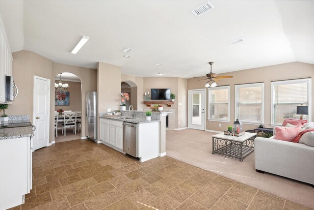 foyer entrance featuring light colored carpet and ceiling fan