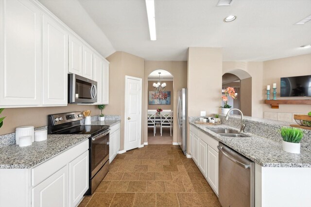 carpeted dining space featuring an inviting chandelier, crown molding, and vaulted ceiling