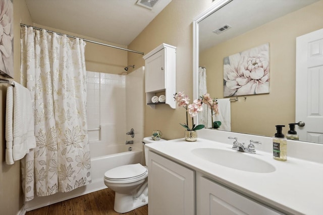 bathroom with vanity, shower / bath combo with shower curtain, toilet, and visible vents