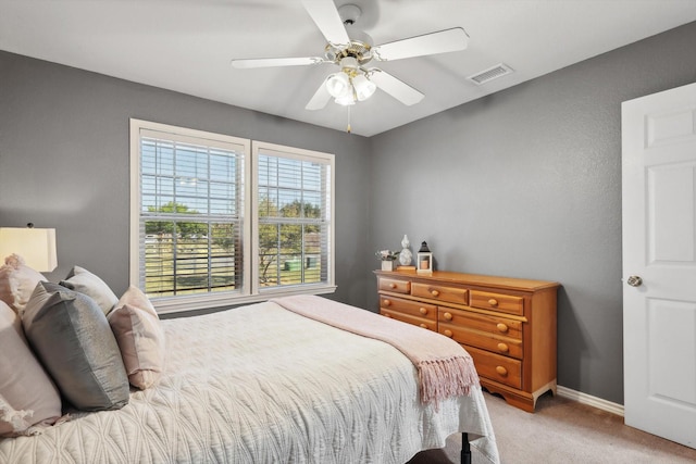 bedroom featuring a ceiling fan, light colored carpet, visible vents, and baseboards