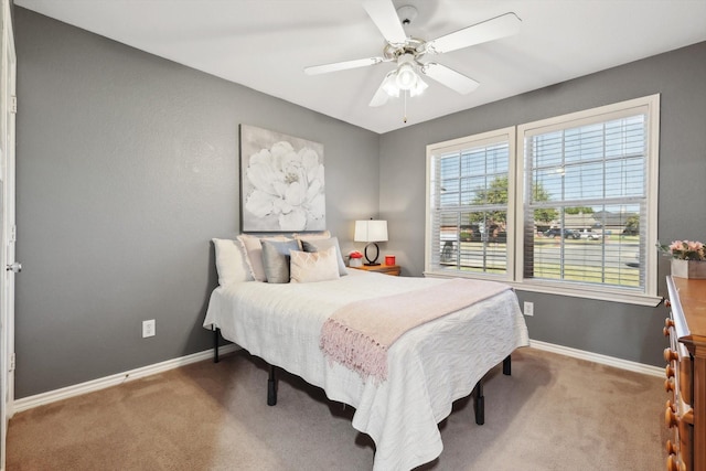 carpeted bedroom featuring baseboards and ceiling fan