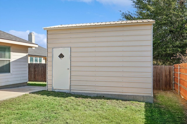 view of outbuilding featuring a lawn