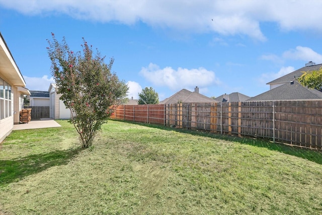 view of yard with a patio and a fenced backyard