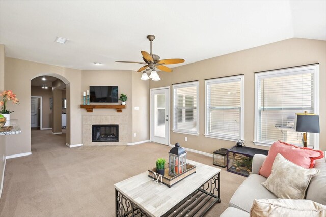 carpeted living room with crown molding and ceiling fan