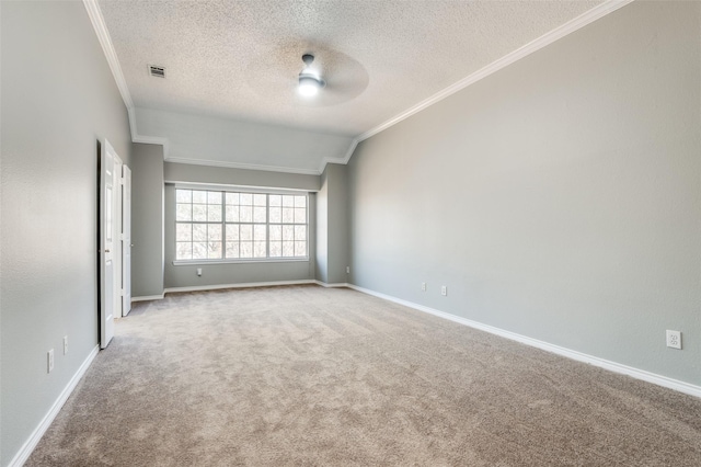 carpeted empty room with ceiling fan, ornamental molding, and a textured ceiling