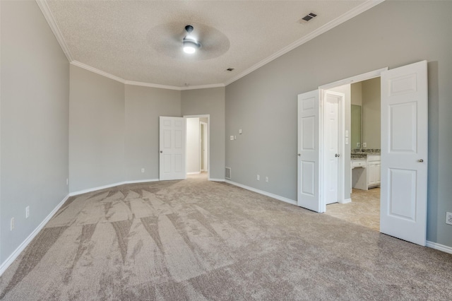 unfurnished bedroom with crown molding, light carpet, ceiling fan, and a textured ceiling