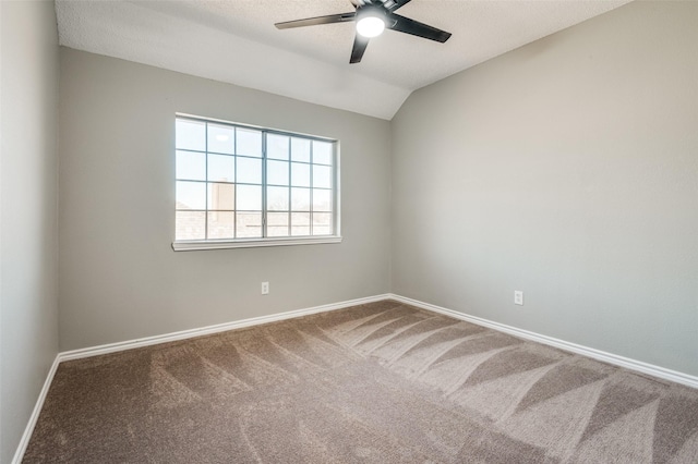 carpeted spare room with ceiling fan, vaulted ceiling, and a textured ceiling