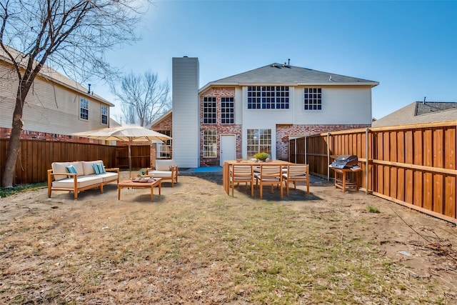 rear view of property with an outdoor living space