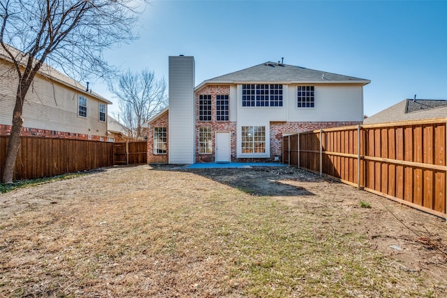 rear view of property with a lawn