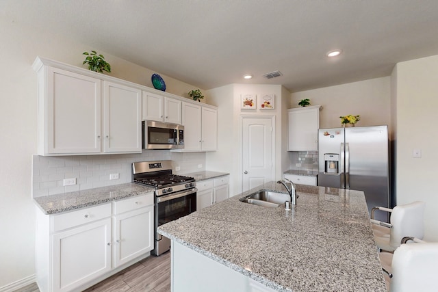 kitchen featuring white cabinetry, stainless steel appliances, and sink