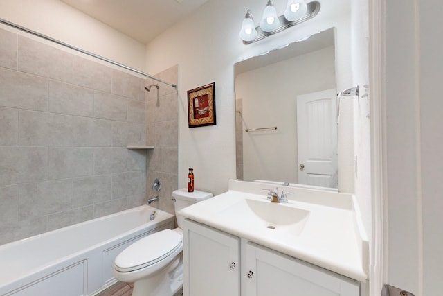 full bathroom with vanity, toilet, and tiled shower / bath combo