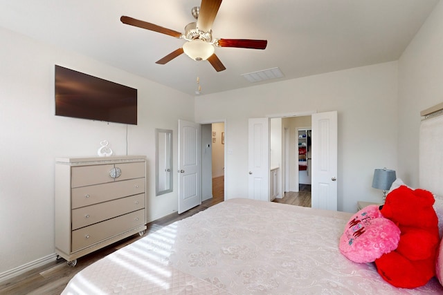 bedroom with hardwood / wood-style floors and ceiling fan