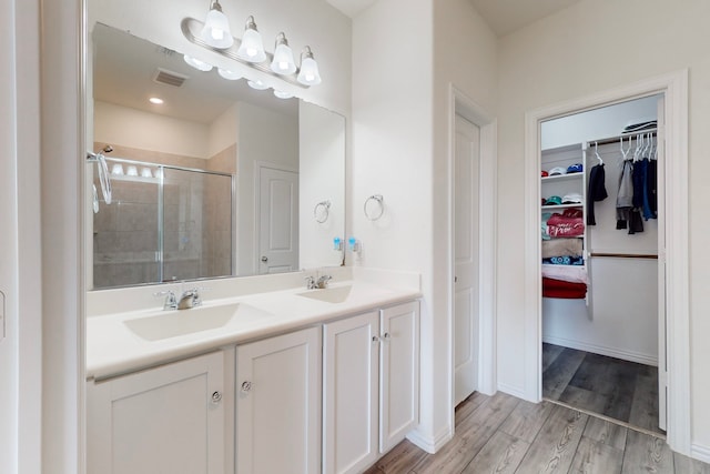 bathroom featuring vanity, hardwood / wood-style floors, and walk in shower