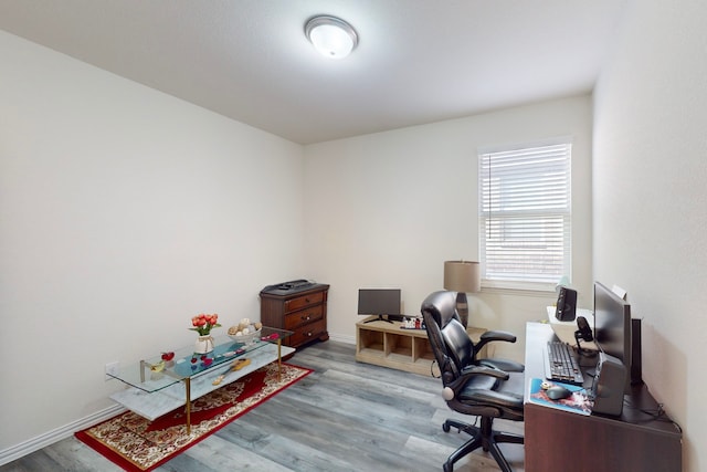 home office with hardwood / wood-style flooring